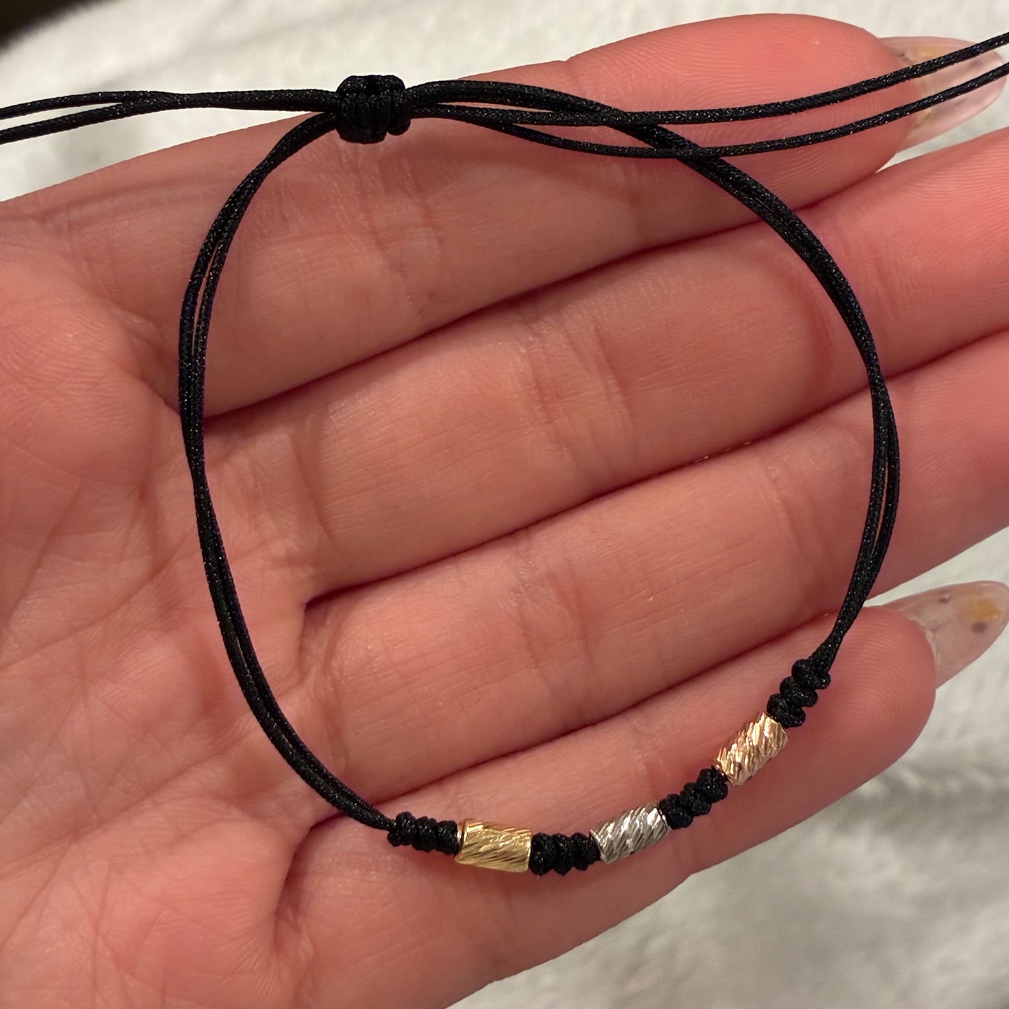 BLACK THREAD BRACELET WITH 3 DIAMOND-CUT CYLINDERS 3MM, THREE 18K GOLD TONES - 0.26GR