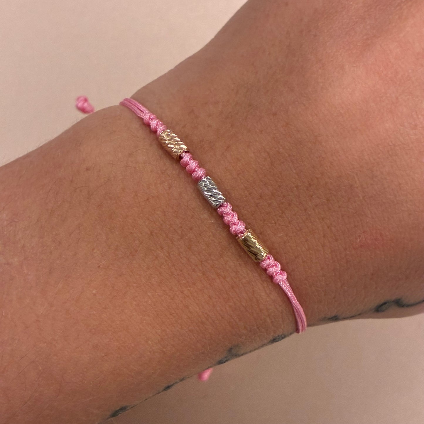 PINK THREAD BRACELET WITH 3 DIAMOND-CUT CYLINDERS 3MM, THREE 18K GOLD TONES - 0.26GR