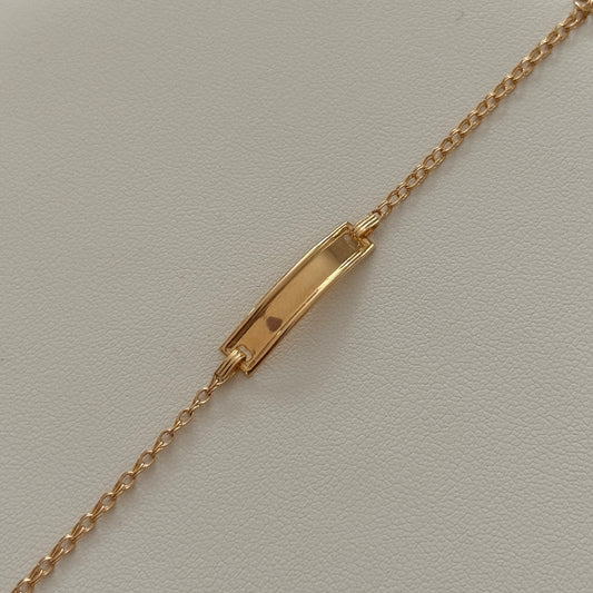 PULSERA ARO SEGUIDO PARA BEBE CON PLACA DE BISEL LISO ORO AMARILLO 18K 15,5CM - 1,26GR