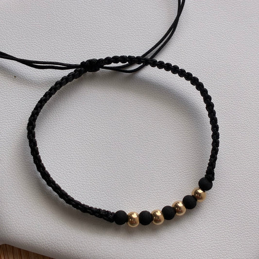 PULSERA HILO NEGRO 4 BOLAS LISAS 4M ORO AMARILLO 18K - 0,36GR