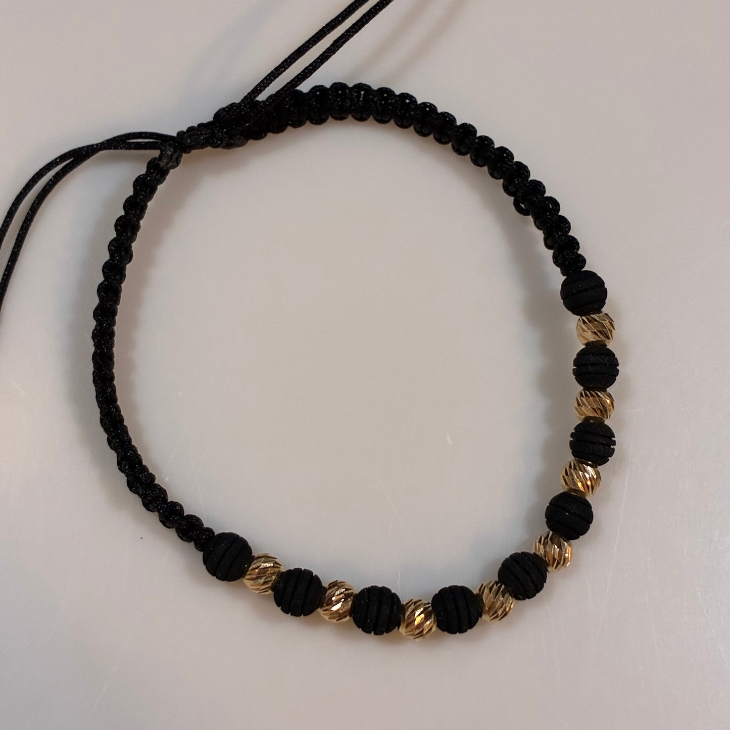 BLACK THREAD BRACELET WITH 8 DIAMOND-CUT BEADS 4MM 18K YELLOW GOLD - 0.95GR