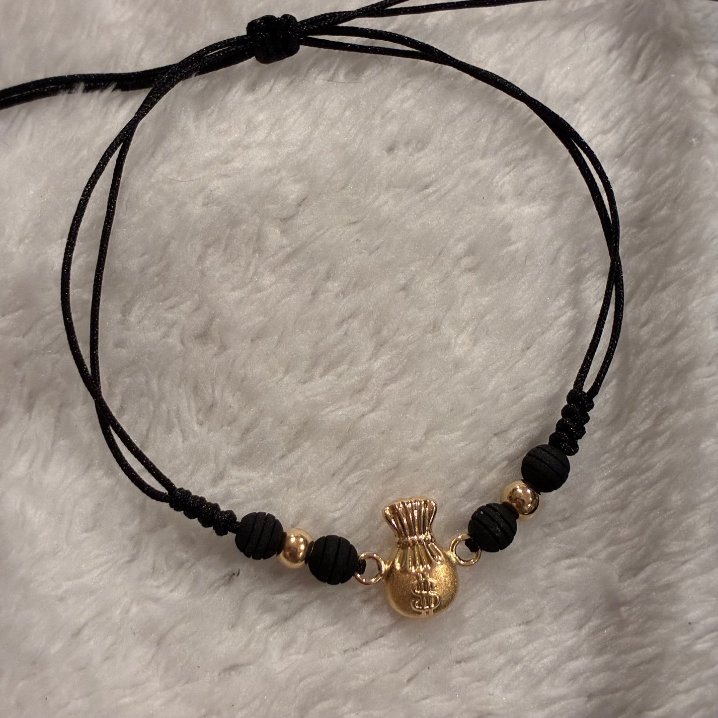 BLACK THREAD BRACELET MONEY BAG CHARM + 2 4M 18K YELLOW GOLD BEADS - 0.66GR