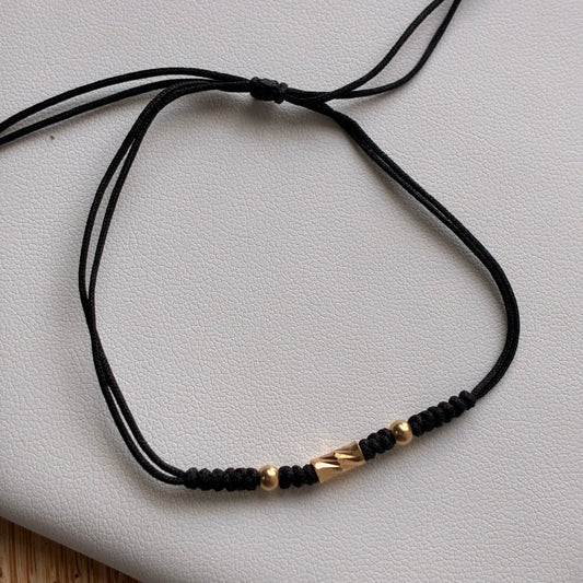 PULSERA HILO NEGRO 1 CILINDRO + 2 BOLAS LISAS 3M ORO AMARILLO 18K - 0,25GR